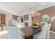 Cozy dining area with views of the kitchen and living space boasts modern light fixture at 11656 N San Clemente St, Surprise, AZ 85388