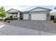 Well-maintained home featuring a spacious driveway, a two-car garage, and a landscaped front yard, enhancing its curb appeal at 11656 N San Clemente St, Surprise, AZ 85388
