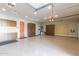 Spacious garage with epoxy floors, storage cabinets, and work area perfect for projects and parking at 11656 N San Clemente St, Surprise, AZ 85388
