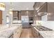 Gourmet kitchen features stainless steel appliances, custom cabinets, and a spacious island at 11656 N San Clemente St, Surprise, AZ 85388