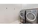 This laundry room offers modern appliances and storage space to suit your washing and drying needs at 11656 N San Clemente St, Surprise, AZ 85388