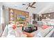 Comfortable living room features a large sectional sofa, custom built-ins, and modern fireplace at 11656 N San Clemente St, Surprise, AZ 85388