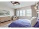 Sunlit main bedroom boasts wood floors, large windows, and a cozy sitting area at 11656 N San Clemente St, Surprise, AZ 85388