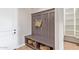 Mud room featuring coat hooks, bench seating, and built-in storage cubbies, ideal for organization at 11656 N San Clemente St, Surprise, AZ 85388