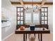 Bright home office featuring wooden beams, modern lighting, and built-in cabinets at 11656 N San Clemente St, Surprise, AZ 85388