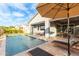 Relax by the refreshing pool, complemented by a covered patio and inviting lounge chairs on the travertine deck at 11656 N San Clemente St, Surprise, AZ 85388