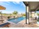 Serene pool view with sun loungers, landscaping, and a glimpse of the home's elegant outdoor living space at 11656 N San Clemente St, Surprise, AZ 85388