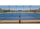 Community tennis court featuring lighting and fencing at 11656 N San Clemente St, Surprise, AZ 85388