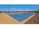View of community tennis court, showing lights and fencing at 11656 N San Clemente St, Surprise, AZ 85388
