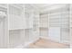 Custom walk-in closet with adjustable shelving, hanging rods, and drawers for optimal storage at 11656 N San Clemente St, Surprise, AZ 85388