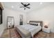 Spacious bedroom featuring wood floors, a large mirror and an ensuite bathroom at 12633 N 81St St, Scottsdale, AZ 85260