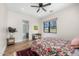 Well-lit bedroom with wood floors, ceiling fan, and en-suite bathroom featuring a glass door shower at 12633 N 81St St, Scottsdale, AZ 85260