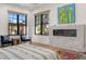 Primary bedroom with a fireplace, a seating area, and views of the backyard at 12633 N 81St St, Scottsdale, AZ 85260
