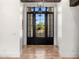 Front door leads to foyer with herringbone flooring and a view of landscaped front yard at 12633 N 81St St, Scottsdale, AZ 85260