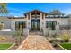 Inviting front elevation with brick pathway, private courtyard, desert landscaping and beamed entry at 12633 N 81St St, Scottsdale, AZ 85260