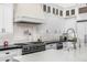 Modern kitchen with island, black countertops, white cabinets and stainless steel appliances at 12633 N 81St St, Scottsdale, AZ 85260