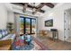 A brightly lit living room with a ceiling fan and French doors that provide outside views at 12633 N 81St St, Scottsdale, AZ 85260