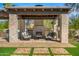 Inviting outdoor seating area with a brick fireplace and comfortable lounge chairs at 12633 N 81St St, Scottsdale, AZ 85260