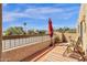 Cozy outdoor balcony with seating and a red umbrella offers views of surrounding landscape at 14645 N Fountain Hills Blvd # 208, Fountain Hills, AZ 85268