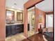 Bathroom with dual sinks, decorative mirrors, and tile floors at 14645 N Fountain Hills Blvd # 208, Fountain Hills, AZ 85268