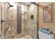 Beautiful walk-in shower with decorative tile accent and glass enclosure in a remodeled bathroom at 14645 N Fountain Hills Blvd # 208, Fountain Hills, AZ 85268
