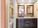Bathroom with stone counters, decorative mirrors, and stylish vessel sink at 14645 N Fountain Hills Blvd # 208, Fountain Hills, AZ 85268