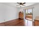 Bright bedroom with hardwood floors, ceiling fan, and sliding glass doors to outdoor balcony at 14645 N Fountain Hills Blvd # 208, Fountain Hills, AZ 85268