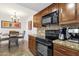 Kitchen showing granite counters and adjacent dining area at 14645 N Fountain Hills Blvd # 208, Fountain Hills, AZ 85268