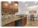 Classic eat-in kitchen featuring granite counters, tile backsplash, and stainless steel dishwasher at 14645 N Fountain Hills Blvd # 208, Fountain Hills, AZ 85268
