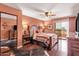 Bedroom with wood floors, ceiling fan, and access to a private balcony at 14645 N Fountain Hills Blvd # 208, Fountain Hills, AZ 85268