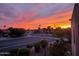 Sunrise over the neighborhood; fiery orange and pink sky over the landscape of homes and palm trees at 14645 N Fountain Hills Blvd # 208, Fountain Hills, AZ 85268
