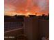 Balcony view of a colorful sunrise over a neighborhood, showcasing desert landscape and palm trees at 14645 N Fountain Hills Blvd # 208, Fountain Hills, AZ 85268