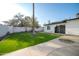 Lush backyard with synthetic grass and mature trees offering shade at 1633 E Wesleyan E Dr, Tempe, AZ 85282