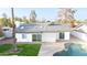 Overhead shot of backyard showcasing covered patio, pool, and lush green grass at 1633 E Wesleyan E Dr, Tempe, AZ 85282