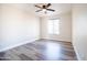 Bedroom offers natural light, modern ceiling fan, and laminate wood floors at 1633 E Wesleyan E Dr, Tempe, AZ 85282