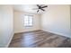 Bedroom showcasing brick accent wall, window, and modern wood flooring at 1633 E Wesleyan E Dr, Tempe, AZ 85282