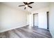 Bedroom featuring ceiling fan, laminate wood floors, and sliding closet doors at 1633 E Wesleyan E Dr, Tempe, AZ 85282