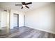 This bedroom includes ceiling fan, wood floors, and sliding closet doors at 1633 E Wesleyan E Dr, Tempe, AZ 85282