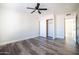 Bright bedroom features modern ceiling fan, wood floors, and sliding closet doors at 1633 E Wesleyan E Dr, Tempe, AZ 85282