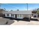 A well-maintained home features a carport, desert landscaping, and white brick exterior under a clear sky at 1633 E Wesleyan E Dr, Tempe, AZ 85282