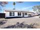 Charming home featuring desert landscaping, a carport, and a well-maintained exterior under a clear sky at 1633 E Wesleyan E Dr, Tempe, AZ 85282