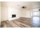 Spacious living room featuring a brick fireplace, ceiling fan, and wood-look flooring, offering modern comfort at 1633 E Wesleyan E Dr, Tempe, AZ 85282