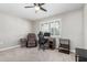 Bedroom featuring a ceiling fan, home office, and neutral carpet at 17822 N Del Webb Blvd, Sun City, AZ 85373