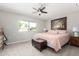 Bright bedroom featuring a ceiling fan, comfortable carpet, and a window view at 17822 N Del Webb Blvd, Sun City, AZ 85373