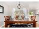 Elegant dining room featuring a wooden table with leather seating, chandelier, and natural light at 17822 N Del Webb Blvd, Sun City, AZ 85373