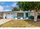 Charming single-story home featuring a teal-painted door, teal-colored porch decor, and a well-maintained front yard at 17822 N Del Webb Blvd, Sun City, AZ 85373