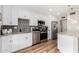 Modern kitchen with white cabinets, stainless steel appliances, granite countertops, and decorative backsplash at 17822 N Del Webb Blvd, Sun City, AZ 85373