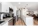 Updated kitchen with granite countertops, stainless steel appliances, white cabinetry, and an island with pendant lighting at 17822 N Del Webb Blvd, Sun City, AZ 85373