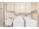 Laundry room featuring a utility sink, washer, dryer, and storage at 17822 N Del Webb Blvd, Sun City, AZ 85373