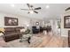 Spacious living area with a large sectional sofa, wood floors, and an open layout to the dining area at 17822 N Del Webb Blvd, Sun City, AZ 85373